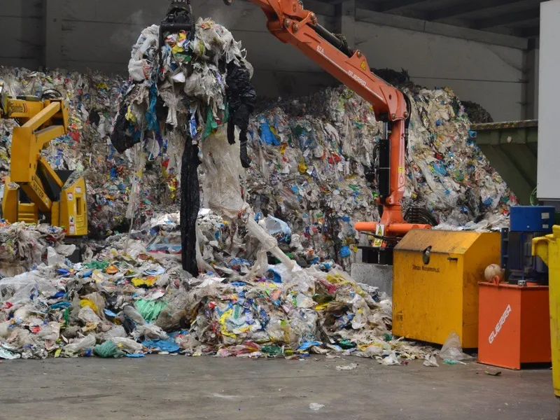 Grappin industriel manipulant des balles de déchets plastiques